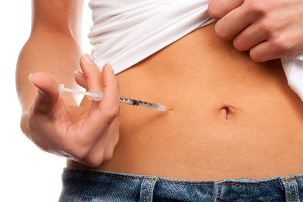 woman with diabetes injecting insulin